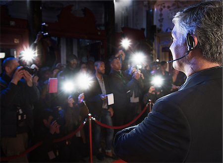 paparazzi camera flash at night - Bodyguard watching paparazzi at red carpet event Stock Photo - Premium Royalty-Free, Code: 6113-07160071