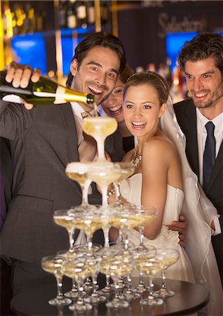 pyramid food - Groom pouring champagne pyramid at wedding reception Stock Photo - Premium Royalty-Free, Code: 6113-07160033