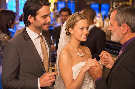 Father holding bride's hands at wedding reception Stock Photo - Premium Royalty-Free, Code: 6113-07160030