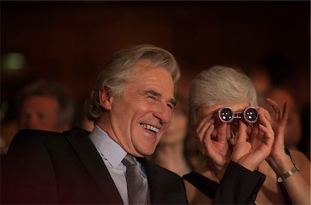 simsearch:6113-07159884,k - Close up of smiling couple using opera glasses in theater audience Foto de stock - Sin royalties Premium, Código: 6113-07160131