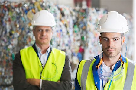 stabilimento per il riciclaggio - Serious workers in recycling center Fotografie stock - Premium Royalty-Free, Codice: 6113-07160249