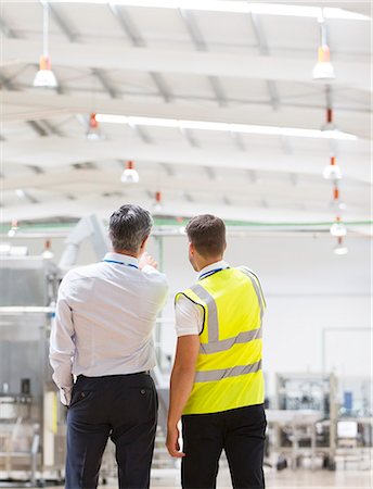 Supervisor and worker talking in warehouse Stock Photo - Premium Royalty-Free, Code: 6113-07160250