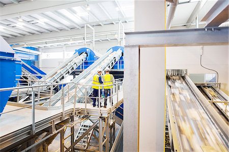 Workers talking on platform in recycling center Stock Photo - Premium Royalty-Free, Code: 6113-07160257