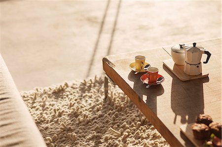 Coffee pot and espresso cups on coffee table in living room Stock Photo - Premium Royalty-Free, Code: 6113-07160239