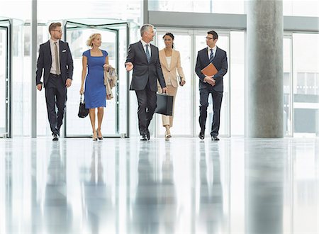 Business people walking in office Stock Photo - Premium Royalty-Free, Code: 6113-07160462