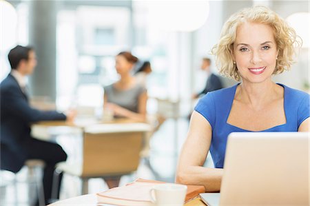 short haired mature women - Businesswoman using laptop in cafe Stock Photo - Premium Royalty-Free, Code: 6113-07160469