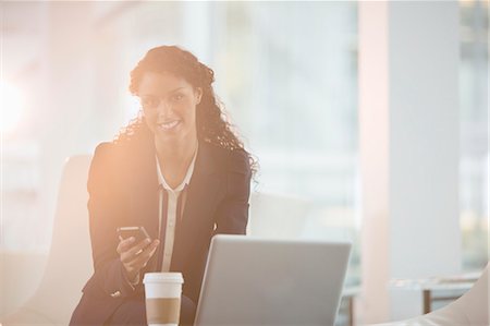 flare copyspace office - Businesswoman using cell phone in office Stock Photo - Premium Royalty-Free, Code: 6113-07160471