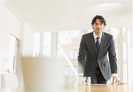 portrait, businessman - Businessman standing at conference table Stock Photo - Premium Royalty-Free, Code: 6113-07160483