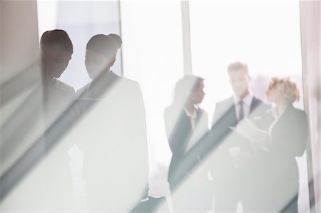 pictures of women standing on men - Business people talking in sunny office Stock Photo - Premium Royalty-Free, Code: 6113-07160402