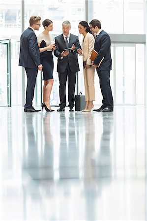 simsearch:6113-07543411,k - Business people talking in office lobby Stock Photo - Premium Royalty-Free, Code: 6113-07160404