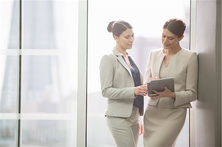 discussion of plan two women - Businesswomen using digital tablet in office Stock Photo - Premium Royalty-Free, Code: 6113-07160431