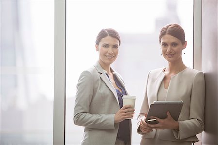 simsearch:6113-07160472,k - Businesswomen smiling in office Stock Photo - Premium Royalty-Free, Code: 6113-07160432