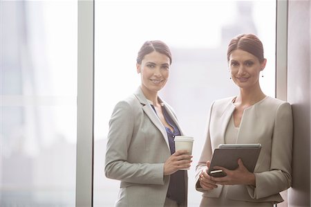 female coffee tablet window - Businesswomen smiling in office Stock Photo - Premium Royalty-Free, Code: 6113-07160432