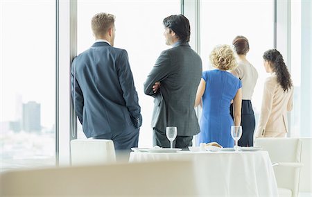 simsearch:6113-07160501,k - Business people looking out window in restaurant Stock Photo - Premium Royalty-Free, Code: 6113-07160535