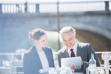 digital tablet outside - Business people talking at sidewalk cafe Stock Photo - Premium Royalty-Free, Code: 6113-07160659