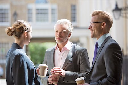 drinking coffee women 40 years old - Business people talking on city street Stock Photo - Premium Royalty-Free, Code: 6113-07160675