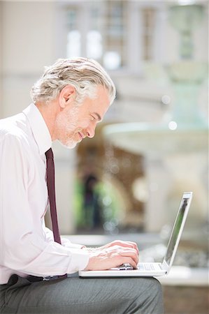 simsearch:6113-06909062,k - Businessman using laptop outdoors Stock Photo - Premium Royalty-Free, Code: 6113-07160681