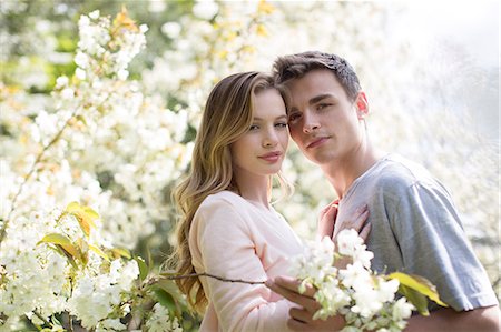 simsearch:6113-07160576,k - Couple hugging under tree with white blossoms Stock Photo - Premium Royalty-Free, Code: 6113-07160607