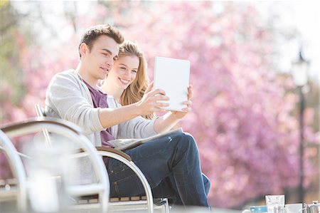 selfie - Couple using digital tablet in park Stock Photo - Premium Royalty-Free, Code: 6113-07160605
