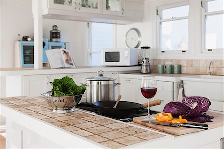 pots on a stove - Vegetables and glass of red wine in kitchen Stock Photo - Premium Royalty-Free, Code: 6113-07160844