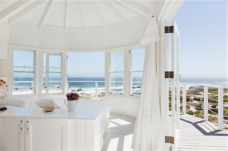 White bedroom overlooking ocean Stock Photo - Premium Royalty-Free, Code: 6113-07160865