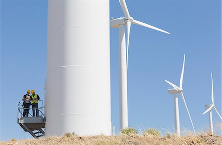 Workers talking on wind turbine in rural landscape Stock Photo - Premium Royalty-Free, Code: 6113-07160884