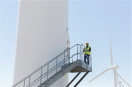Worker standing on wind turbine Stock Photo - Premium Royalty-Free, Code: 6113-07160956