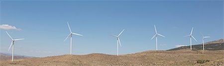 Wind turbines spinning in rural landscape Photographie de stock - Premium Libres de Droits, Code: 6113-07160971