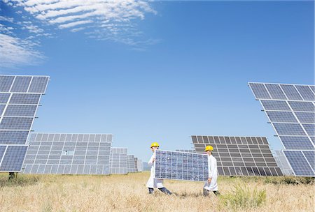 energy and power - Scientists carrying solar panel in rural landscape Stock Photo - Premium Royalty-Free, Code: 6113-07160937