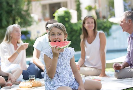 daughter talking to mother - Girl eating watermelon at picnic Stock Photo - Premium Royalty-Free, Code: 6113-07241979