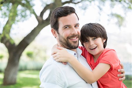 Father and son smiling outdoors Stock Photo - Premium Royalty-Free, Code: 6113-07241987