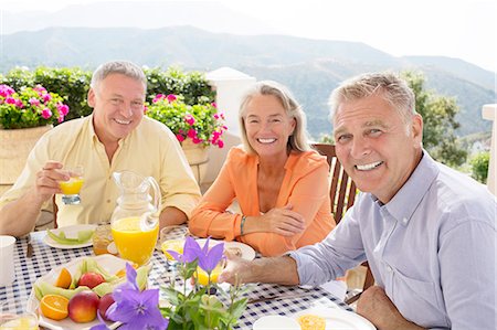 Senior friends enjoying breakfast on balcony Foto de stock - Sin royalties Premium, Código: 6113-07242041