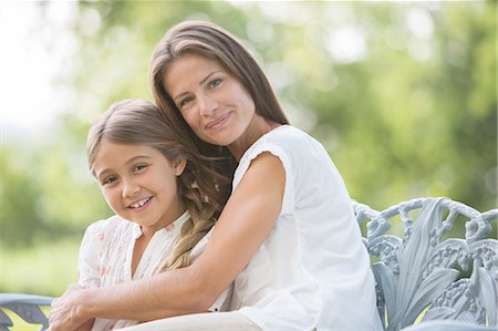 family pictures on a bench - Mother and daughter hugging outdoors Stock Photo - Premium Royalty-Free, Code: 6113-07242092