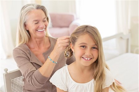 simsearch:6113-06626338,k - Grandmother braiding granddaughter's hair Stock Photo - Premium Royalty-Free, Code: 6113-07242036