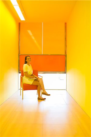 saturated color - Businesswoman sitting in bright office Stock Photo - Premium Royalty-Free, Code: 6113-07242184