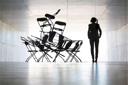 silhouette (darkened or blurred object or figure) - Businesswoman examining office chair installation art Stock Photo - Premium Royalty-Free, Code: 6113-07242190