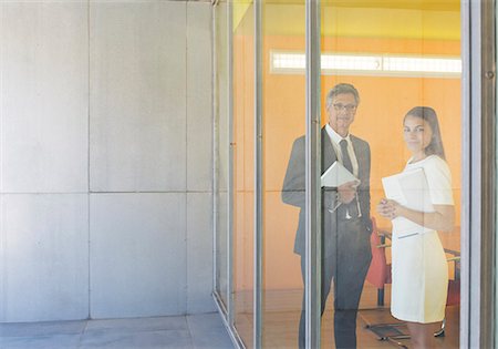 portrait of businesswoman - Business people smiling at office window Stock Photo - Premium Royalty-Free, Code: 6113-07242199