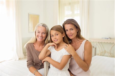 family of three kids hugging - Multi-generation women in bedroom Stock Photo - Premium Royalty-Free, Code: 6113-07242113
