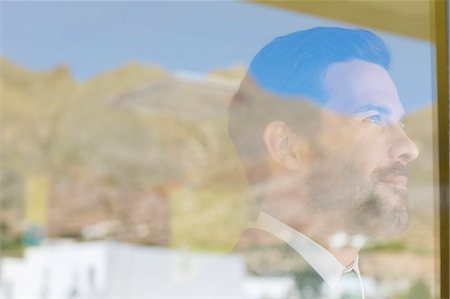 simsearch:6113-07565565,k - Businessman looking out window Stock Photo - Premium Royalty-Free, Code: 6113-07242127