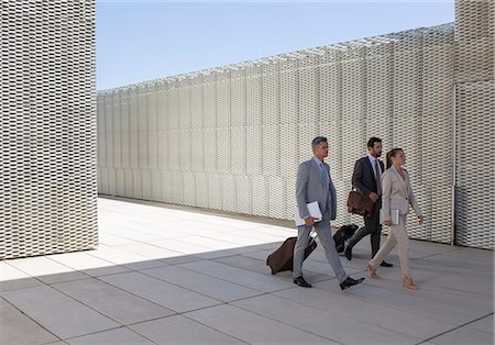 suitcase travel - Business people walking with suitcases outdoors Stock Photo - Premium Royalty-Free, Code: 6113-07242137