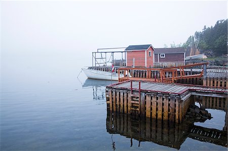 Boathouses and dock on bay Stock Photo - Premium Royalty-Free, Code: 6113-07242293