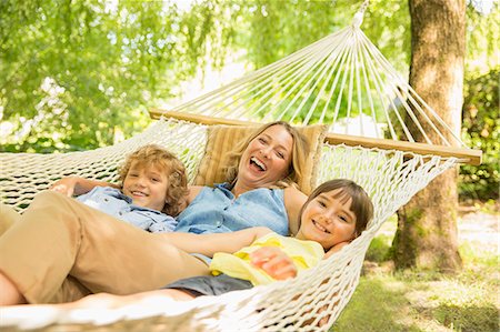 family backyard relaxing - Mother and children relaxing in hammock Stock Photo - Premium Royalty-Free, Code: 6113-07242350