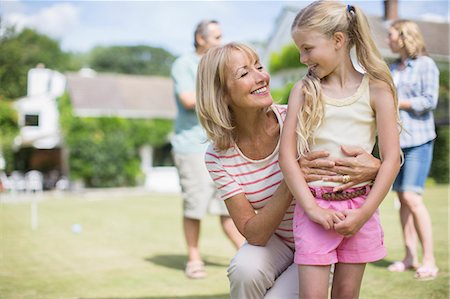 simsearch:6113-06626338,k - Grandmother hugging granddaughter outdoors Stock Photo - Premium Royalty-Free, Code: 6113-07242454