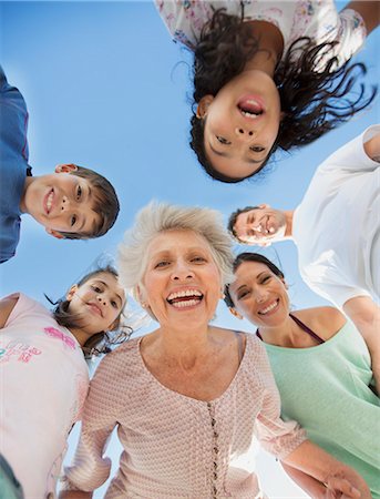 simsearch:6113-06908790,k - Multi-generation family smiling in huddle Stock Photo - Premium Royalty-Free, Code: 6113-07242492