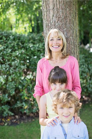 simsearch:6113-06908828,k - Grandmother and grandchildren smiling outdoors Stock Photo - Premium Royalty-Free, Code: 6113-07242410