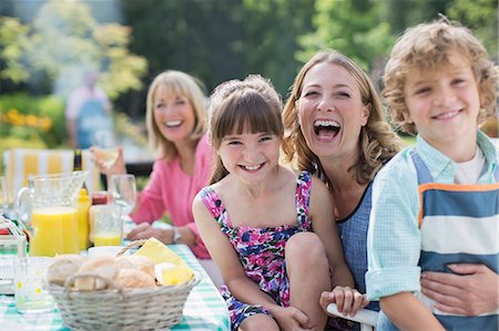 Family at table in backyard Stock Photo - Premium Royalty-Free, Code: 6113-07242427