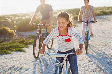 Family riding bicycles on sunny beach Stock Photo - Premium Royalty-Free, Code: 6113-07242542