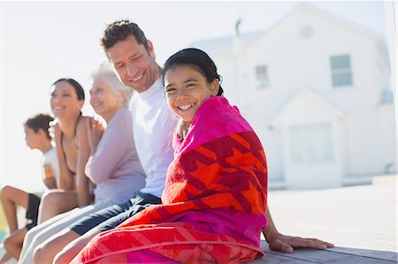 simsearch:6113-06626346,k - Multi-generation family sitting outside beach house Stock Photo - Premium Royalty-Free, Code: 6113-07242516
