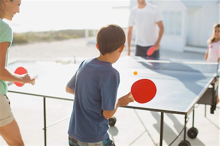 sunlight fun outdoor game - Family playing table tennis together outdoors Stock Photo - Premium Royalty-Free, Code: 6113-07242525