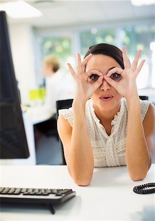 portrait and funny glasses - Businesswoman making a face at desk in office Stock Photo - Premium Royalty-Free, Code: 6113-07242682